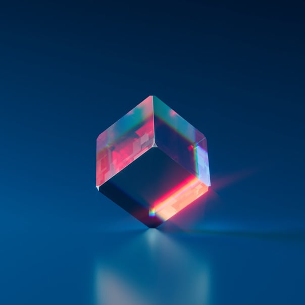 A cube on a dark blue background stands on one corner